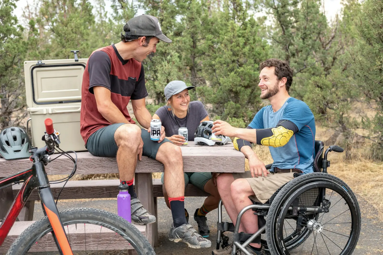 Friends chatting outdoors, one of them a wheelchair user